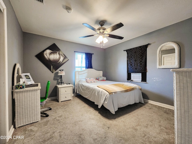 carpeted bedroom featuring cooling unit and ceiling fan