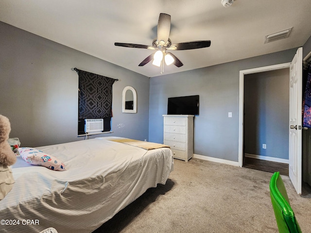 carpeted bedroom with ceiling fan and cooling unit