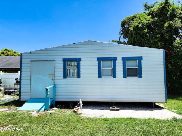 back of property featuring a lawn