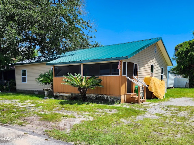 view of front of home featuring a sunroom