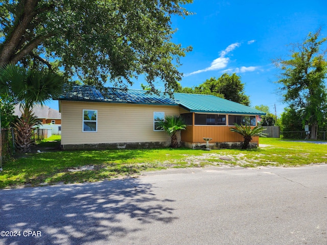 view of property exterior with a lawn