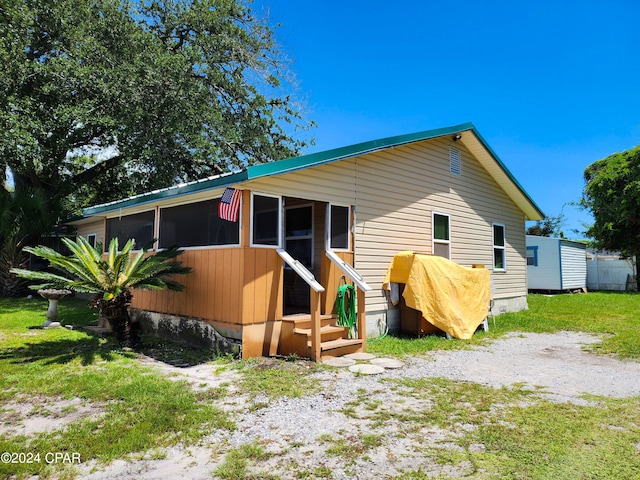 rear view of house with a sunroom