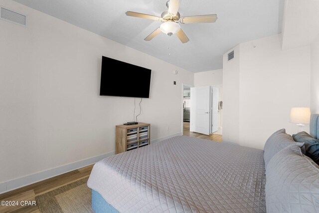 bedroom with light hardwood / wood-style flooring and ceiling fan