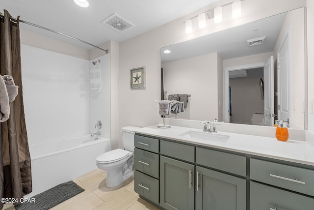 full bathroom featuring tile patterned flooring, bathtub / shower combination, toilet, and vanity