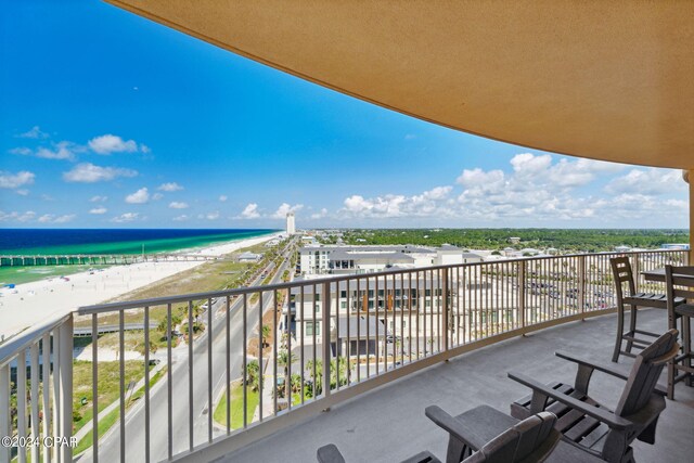 balcony featuring a water view and a view of the beach