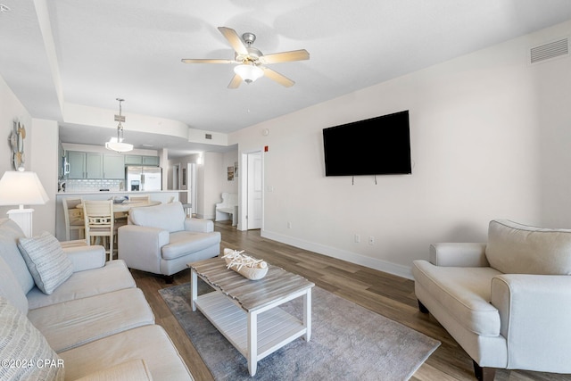 living room featuring hardwood / wood-style flooring and ceiling fan