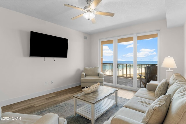 living room featuring light wood-type flooring and ceiling fan