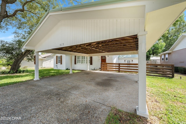 view of front of property with a carport and a front lawn