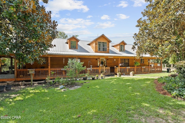 rear view of house featuring a lawn