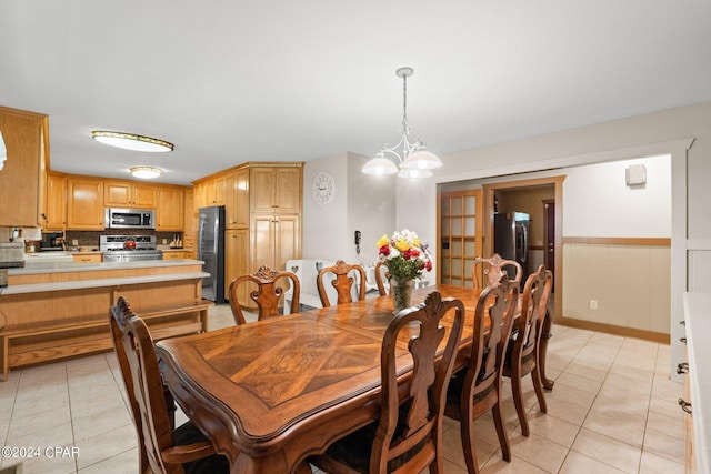 dining space with a notable chandelier and light tile patterned floors