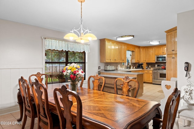 tiled dining room with a notable chandelier