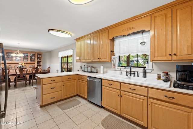 kitchen with dishwasher, sink, hanging light fixtures, light tile patterned floors, and kitchen peninsula