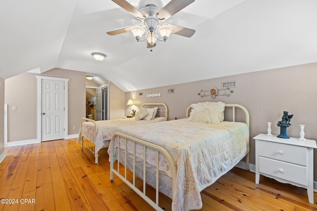 bedroom featuring ceiling fan, vaulted ceiling, and light hardwood / wood-style flooring