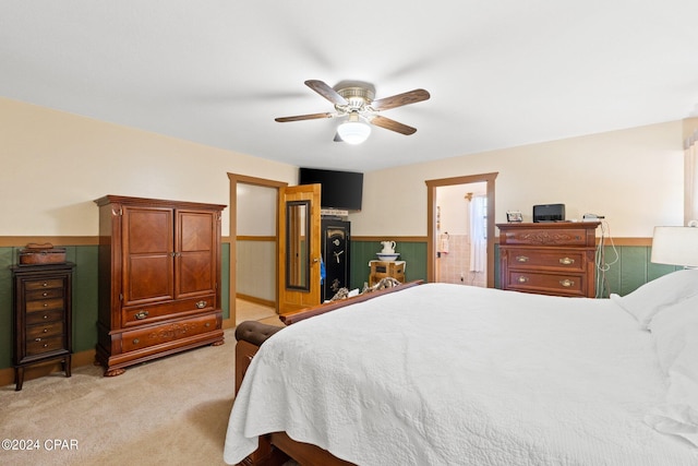 carpeted bedroom featuring connected bathroom and ceiling fan