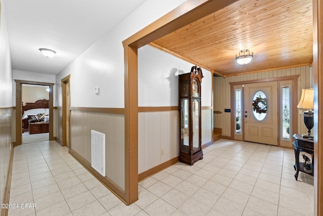 tiled foyer entrance with wooden ceiling