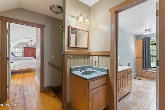 bathroom featuring lofted ceiling, hardwood / wood-style floors, vanity, and plenty of natural light