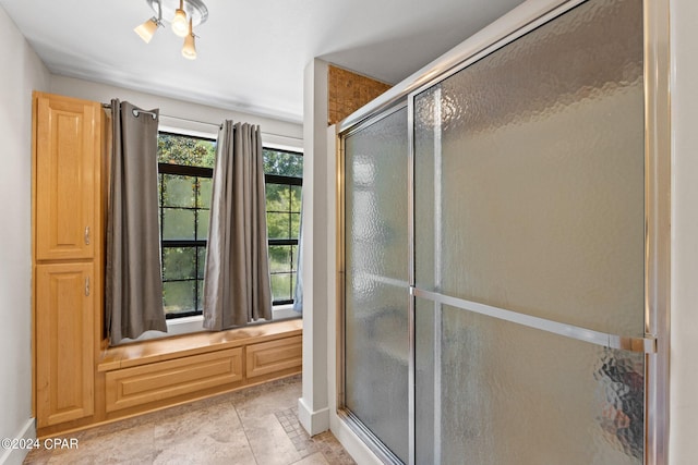 bathroom featuring a shower with shower door