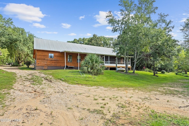 view of front of property featuring a sunroom and a front yard