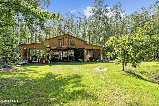 rear view of property with a lawn