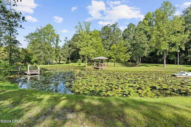 view of property's community featuring a gazebo, a water view, and a yard