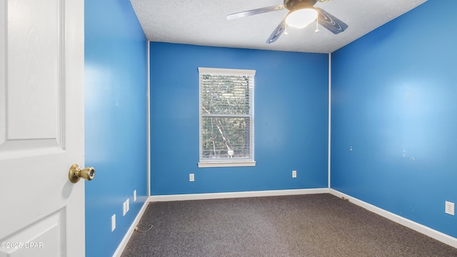 empty room with a ceiling fan, carpet, baseboards, and a textured ceiling