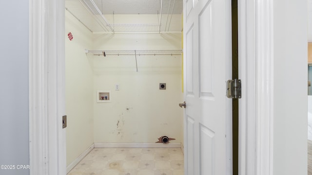 laundry room with hookup for a washing machine, baseboards, light floors, and electric dryer hookup