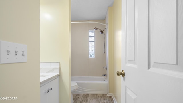 bathroom with shower / bath combination, vanity, toilet, and wood finished floors