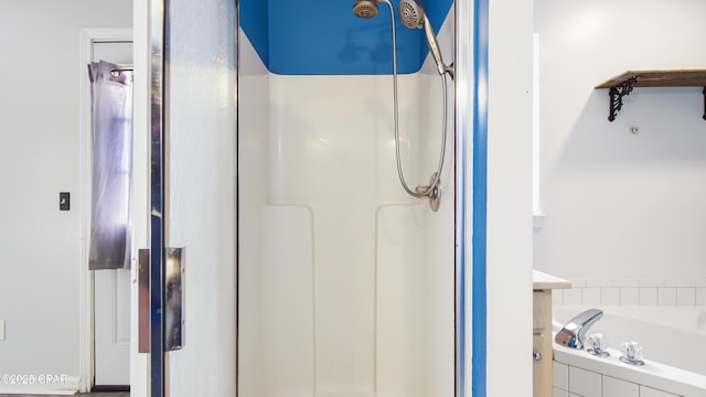 full bath with vanity, a shower stall, and a bath