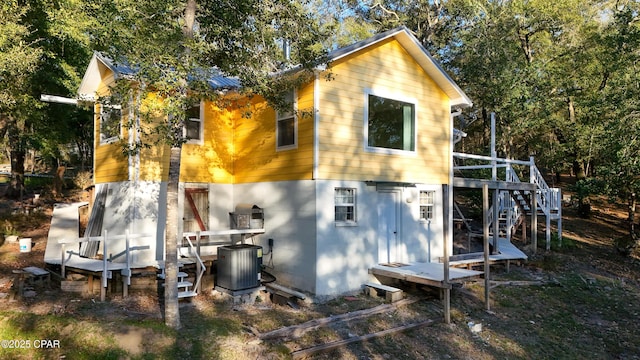 view of outbuilding with stairs and cooling unit