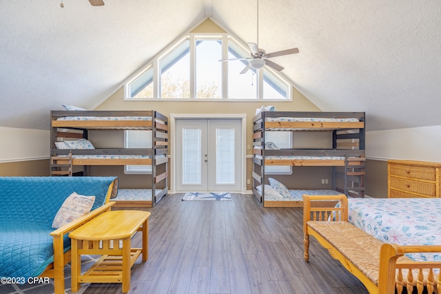 bedroom featuring a textured ceiling, vaulted ceiling, and dark hardwood / wood-style floors