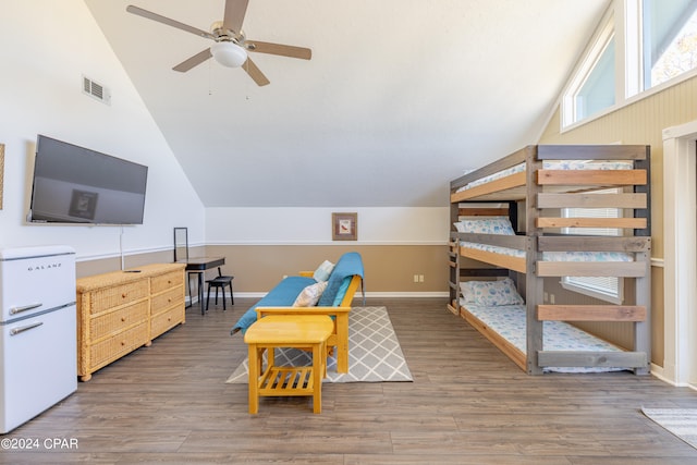 bedroom with vaulted ceiling, ceiling fan, and dark wood-type flooring