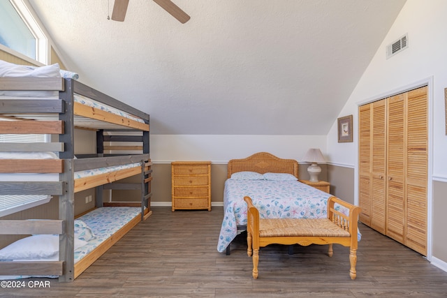 bedroom featuring ceiling fan, a closet, vaulted ceiling, and dark hardwood / wood-style flooring