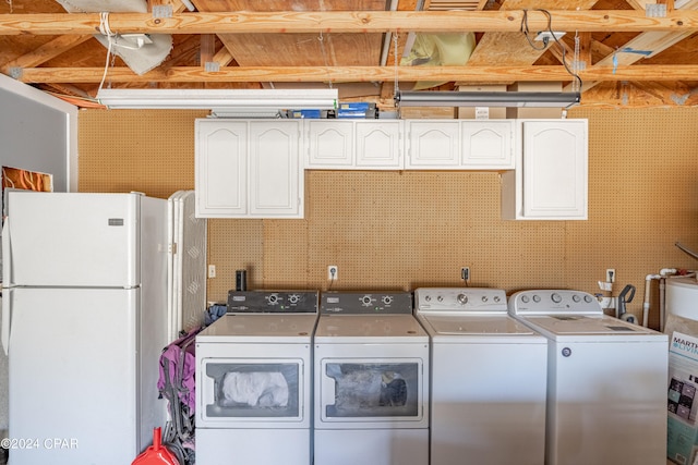 laundry room with water heater and washer and dryer