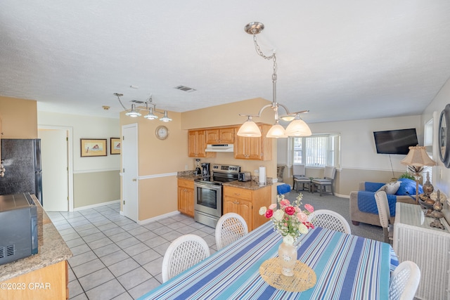 tiled dining room with a textured ceiling