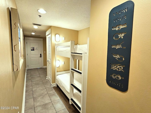 bathroom featuring a textured ceiling and tile patterned floors