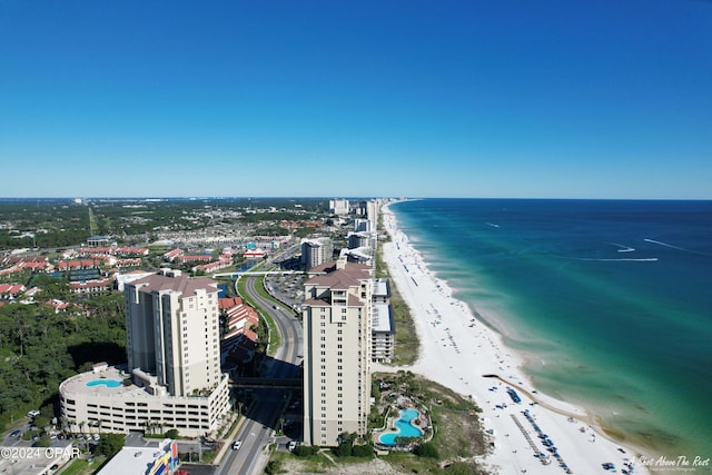 bird's eye view featuring a water view and a beach view