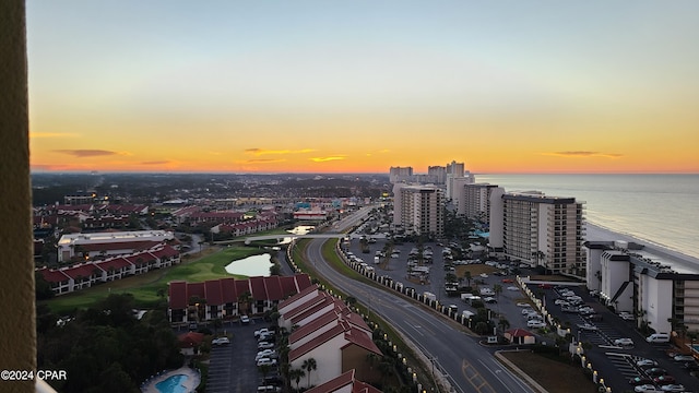 aerial view at dusk featuring a water view