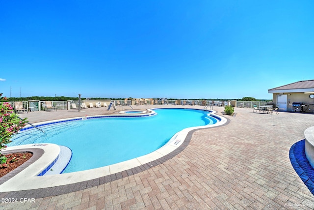 view of swimming pool featuring a patio area