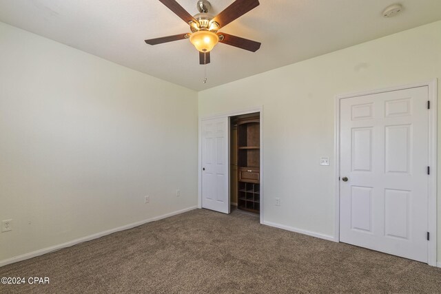 unfurnished bedroom featuring ceiling fan, a closet, and carpet