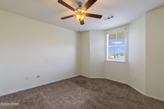 carpeted spare room featuring ceiling fan