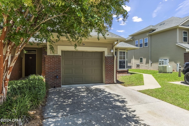 view of front of property featuring a garage and a front lawn