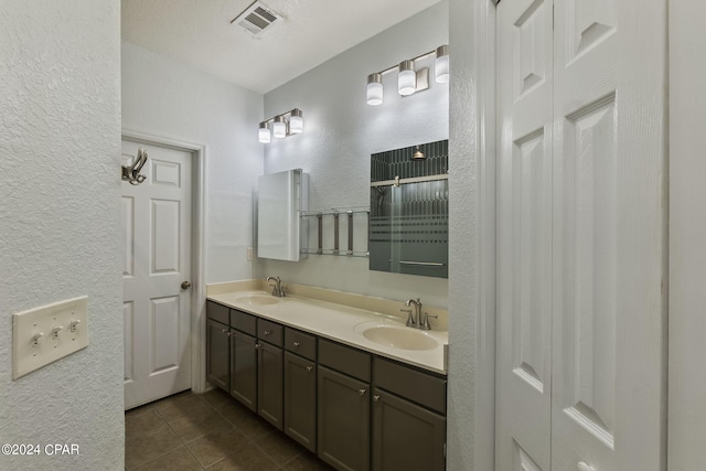 bathroom with walk in shower, tile patterned floors, and vanity