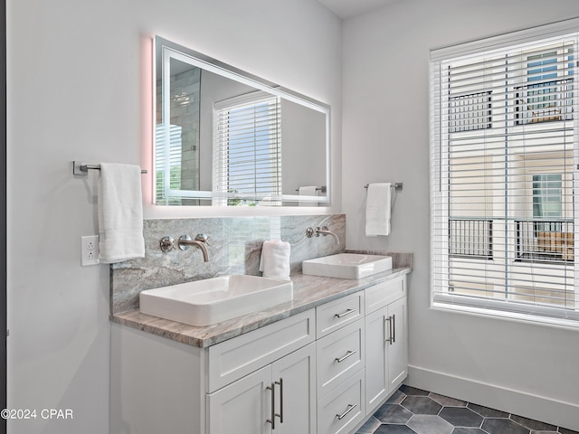 bathroom with decorative backsplash, tile patterned flooring, and vanity