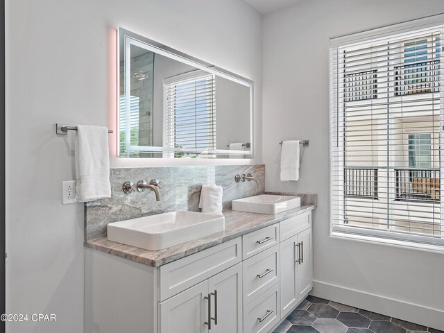 101 Deluna Pl Unit A, Panama City Beach, FL 32413 - full bath featuring backsplash, a wealth of natural light, and a sink