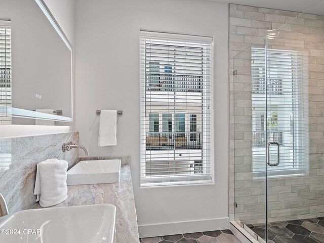 101 Deluna Pl Unit A, Panama City Beach, FL 32413 - full bath featuring baseboards, a sink, and a stall shower