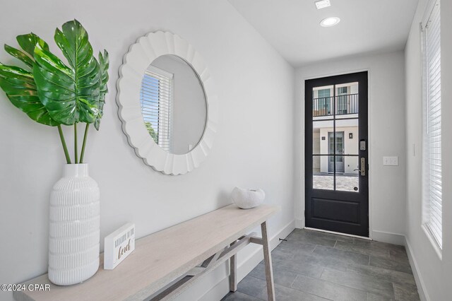 101 Deluna Pl Unit A, Panama City Beach, FL 32413 - doorway to outside with baseboards and a wealth of natural light