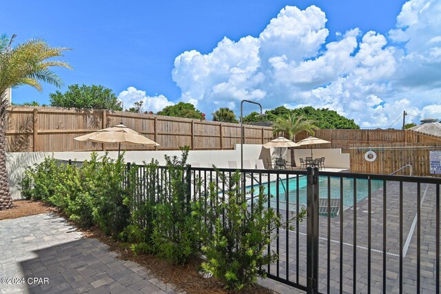 101 Deluna Pl Unit A, Panama City Beach, FL 32413 - pool with a patio area and a fenced backyard