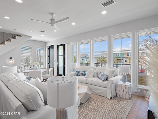 living room featuring ceiling fan and light wood-type flooring