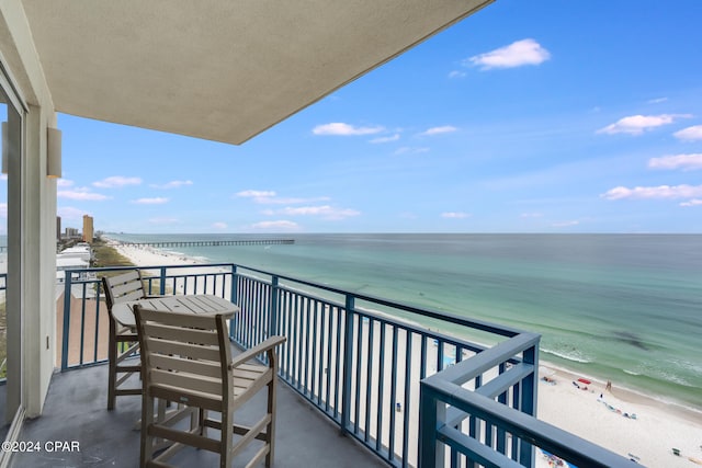 balcony with a beach view and a water view