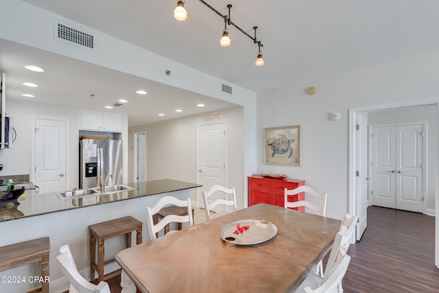 dining space featuring dark hardwood / wood-style flooring and sink